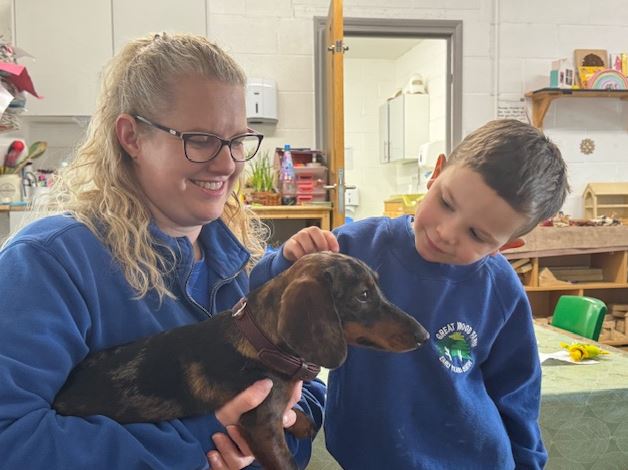 boy petting dog Dachshund