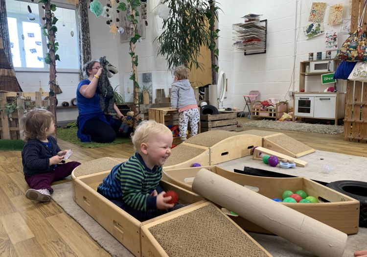 Babies posting, playing with toddle boxes