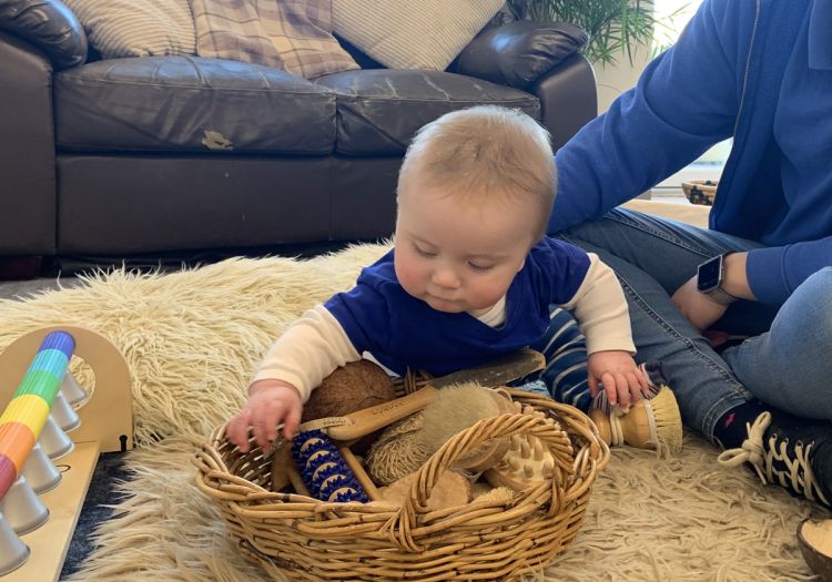 Baby exploring treasure basket