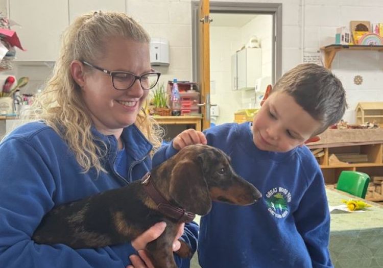 boy petting dog Dachshund